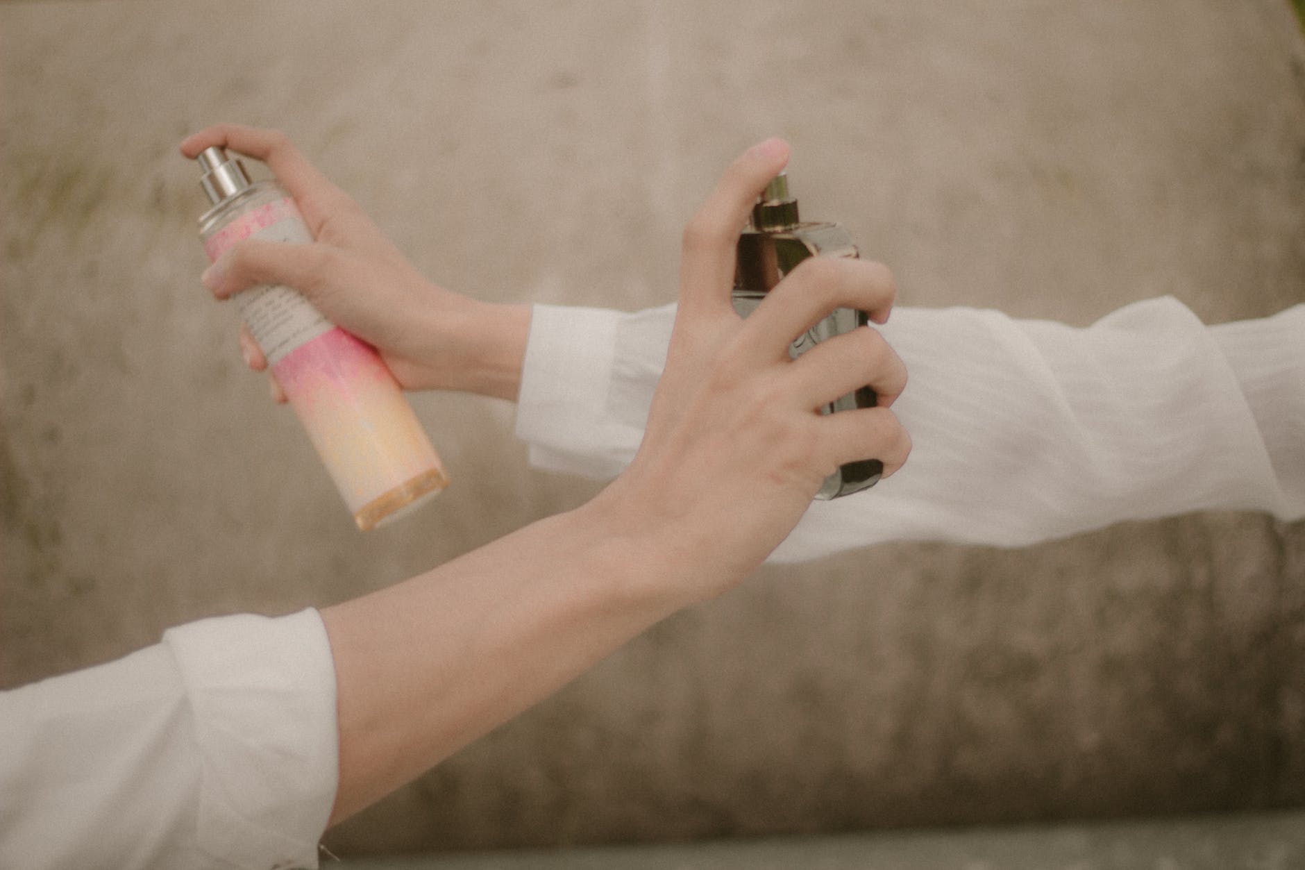 hands holding perfume bottles